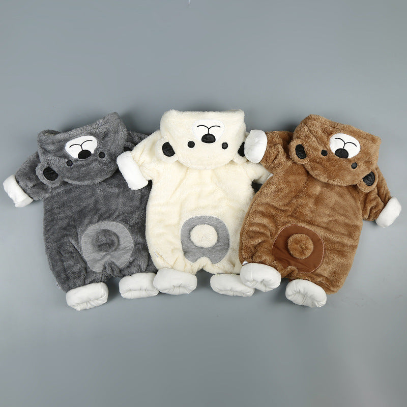 The bear snuggle suit in grey, beige and brown laid flat side by side, each with a plush tail pom-pom